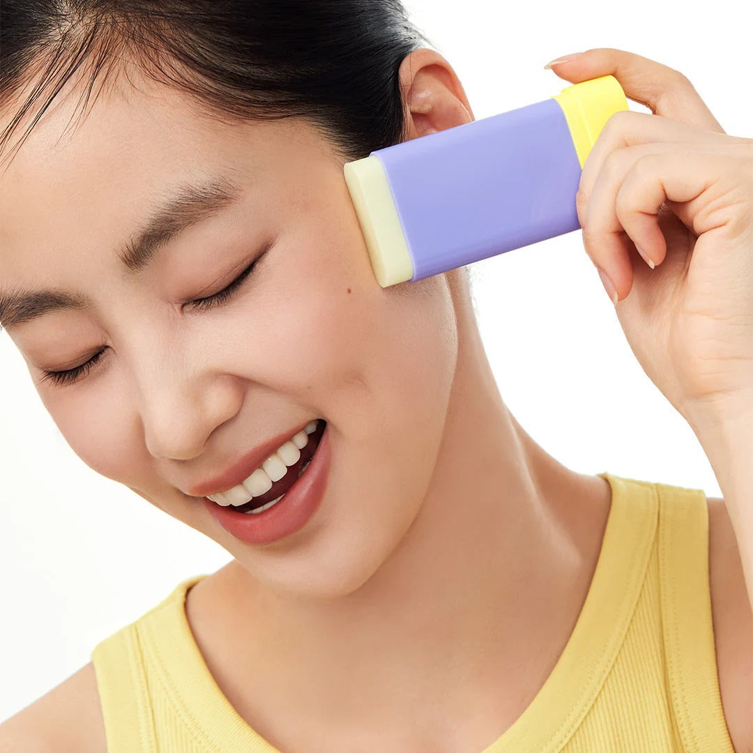 Woman using BY WISHTREND Pore Smoothing Bakuchoil Sun Stick 18g on face