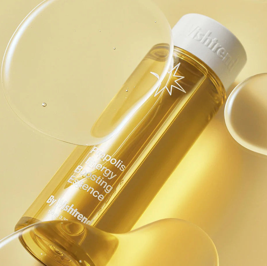 BY WISHTREND Propolis Energy Boosting Essence 100ml bottle with propolis extract on a yellow background