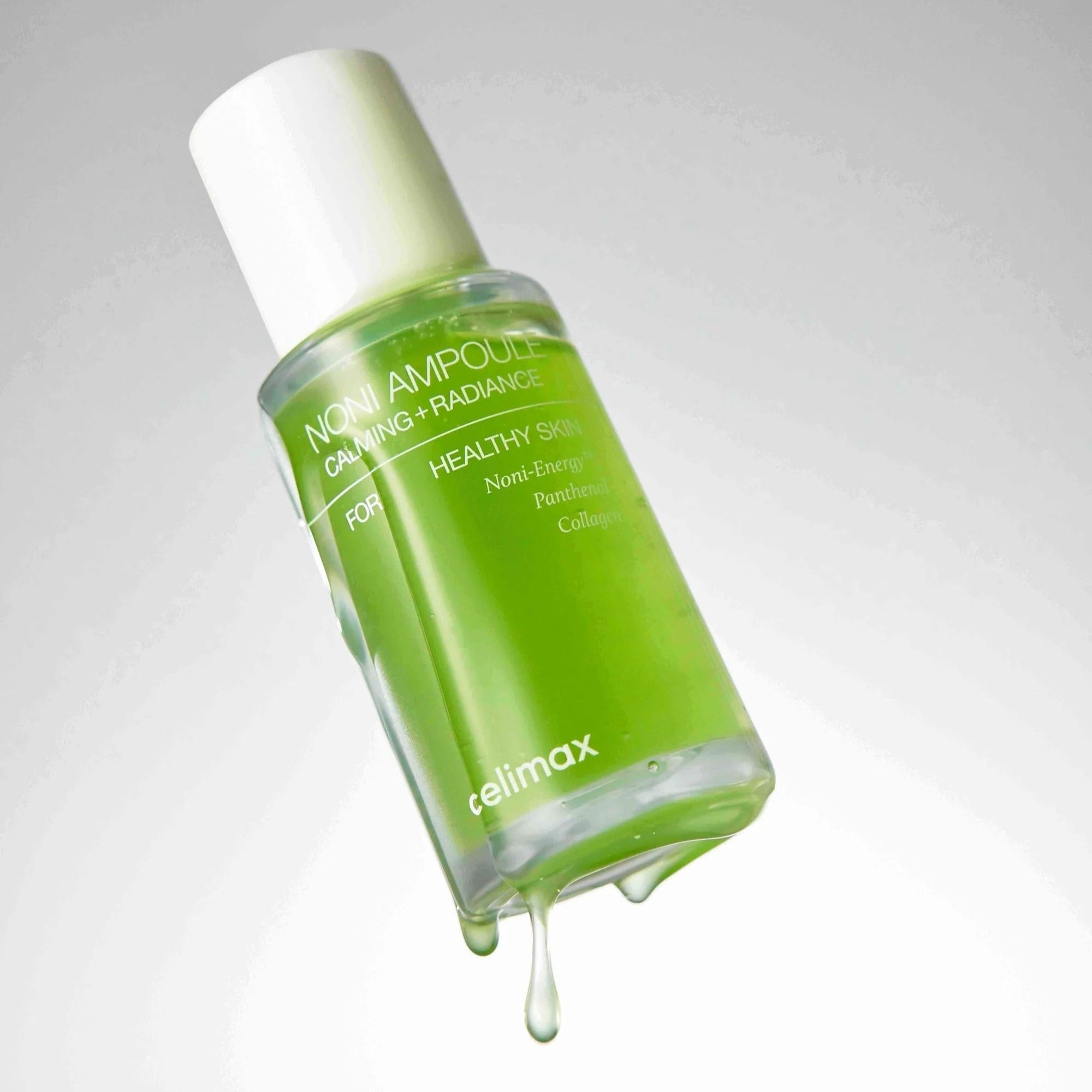 CELIMAX Noni Ampoule Calming+Radiance 100ml bottle with dripping liquid