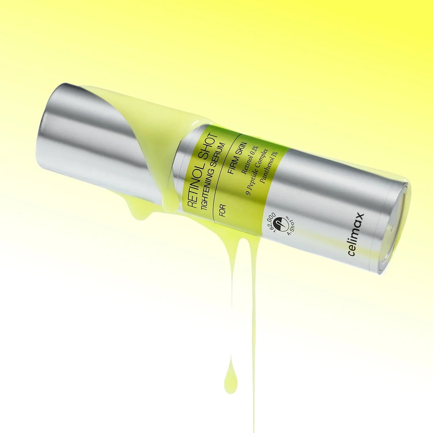 Image of CELIMAX Retinol Shot Tightening Serum 30ml bottle with yellow serum dripping on a yellow background.