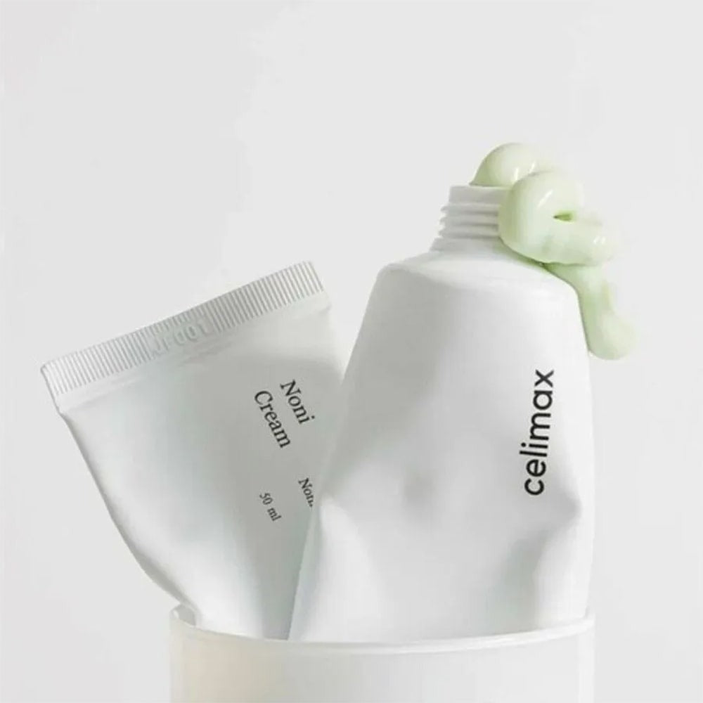 CELIMAX The Real Noni Energy Repair Cream 50ml tubes with cream texture on display.