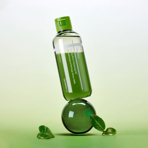 Bottle of CENTELLIAN 24 Madeca Matcha Cleansing Oil 200ml balanced on a green sphere with leaves on a gradient background.