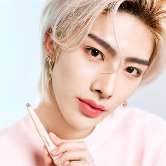Person holding COLORGRAM Re-forming Contour Stick, showcasing makeup application.