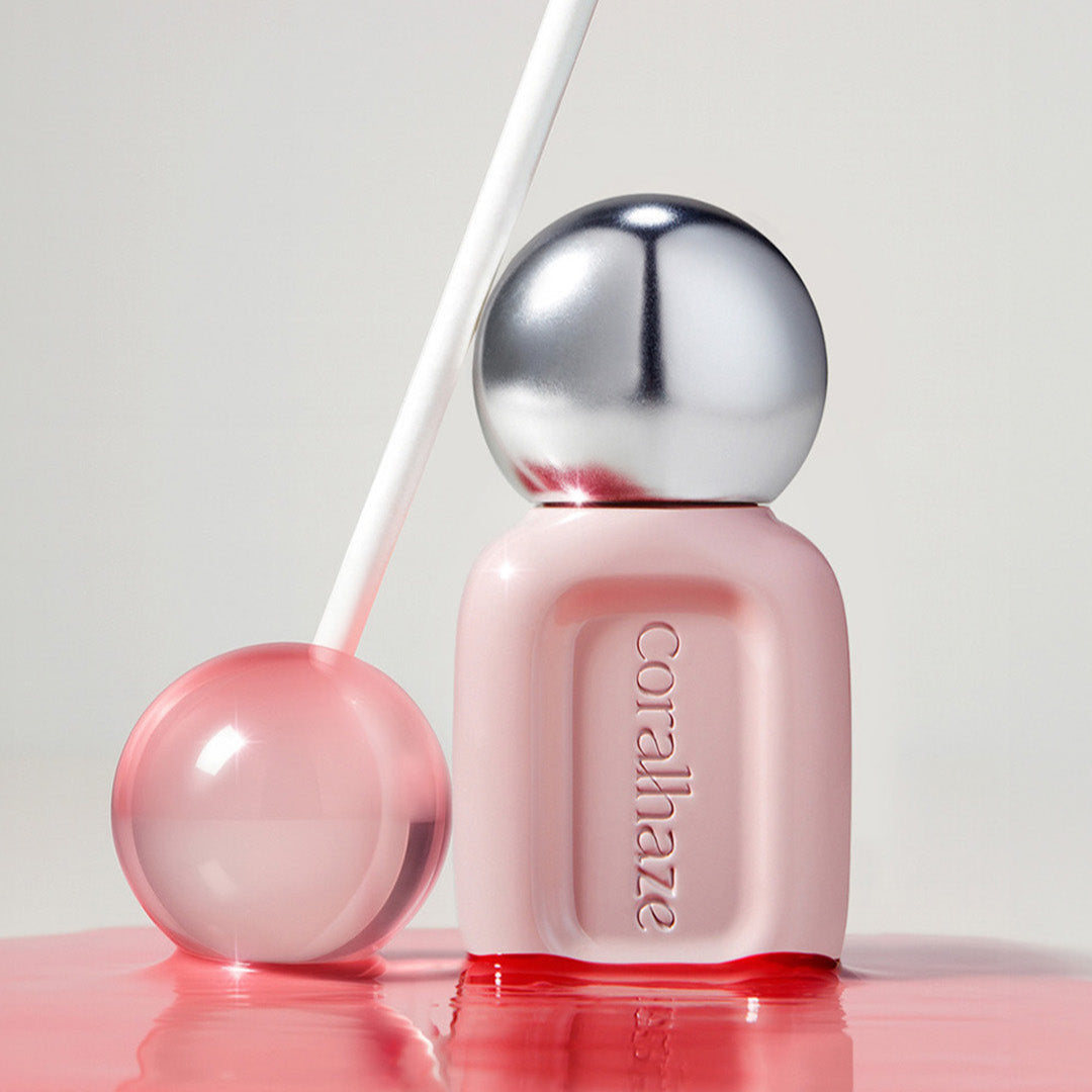 CORALHAZE Dew Drop Tint 4.5g in a sleek pink and silver bottle with a clear lollipop-like sphere, set against a soft background.