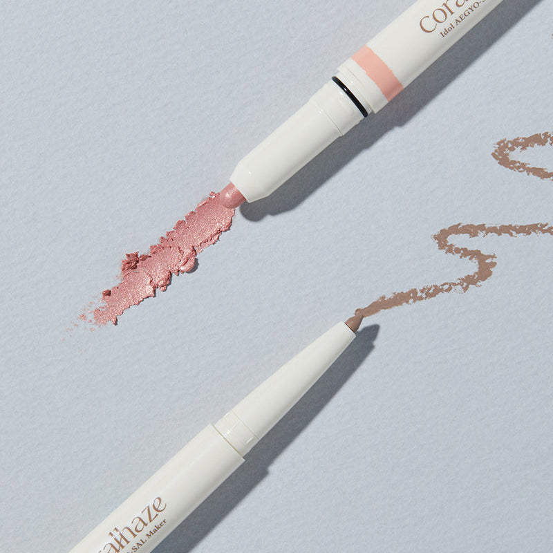 CORALHAZE Idol Aegyo Sal Maker beauty product with two shades of makeup on a light background.