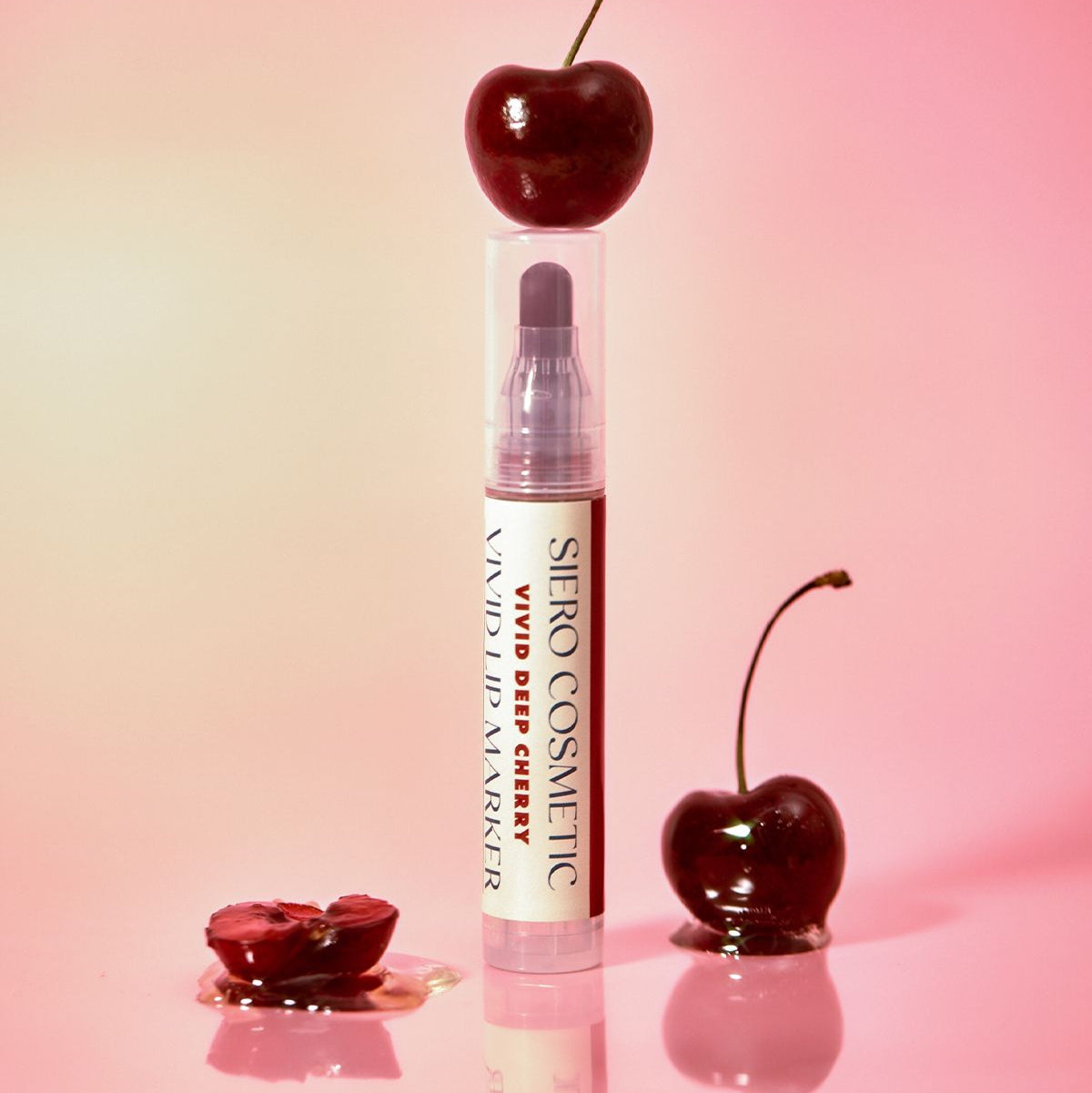 COSIERO Vivid Lip Marker in vibrant cherry shade with fresh cherries backdrop.