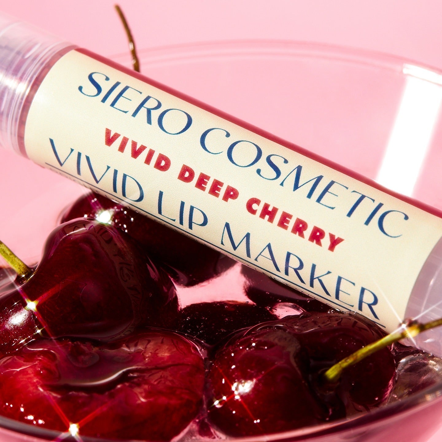 COSIERO Vivid Lip Marker in Deep Cherry shade resting on fresh cherries, showcasing vibrant lip color and fruity inspiration.