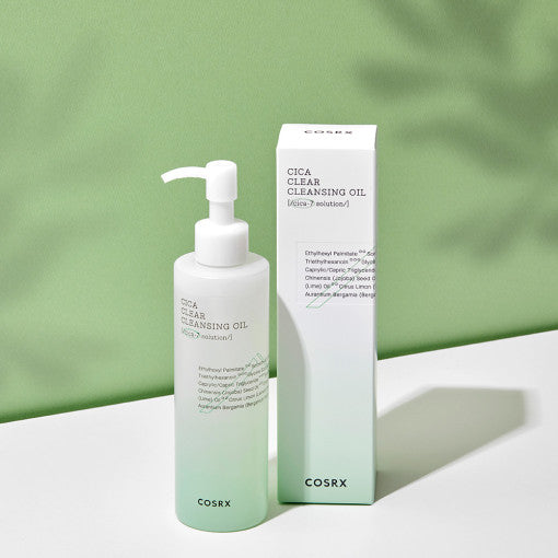 COSRX Pure Fit Cica Cleansing Oil 200ml bottle and packaging against a green background.