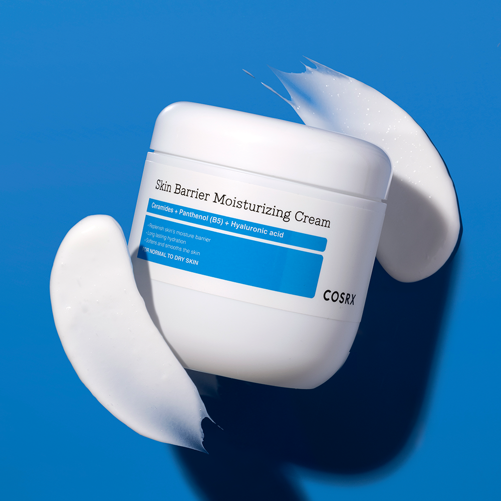 COSRX Skin Barrier Moisturizing Cream 450ml jar with cream texture on blue background