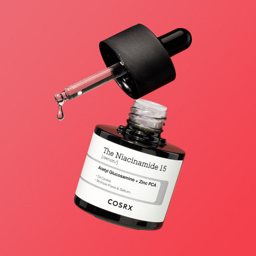 COSRX The Niacinamide 15 Serum 20ml bottle with dropper on red background