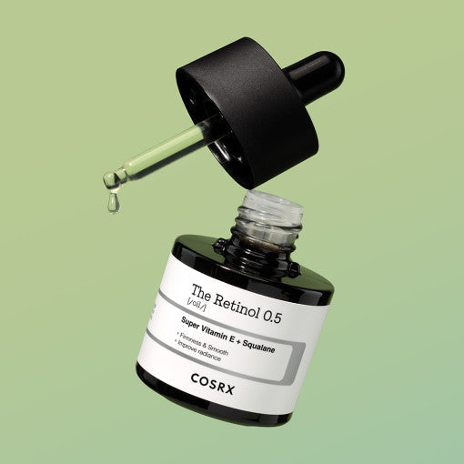 COSRX The Retinol 0.5 Oil 20ml bottle with dropper on green background