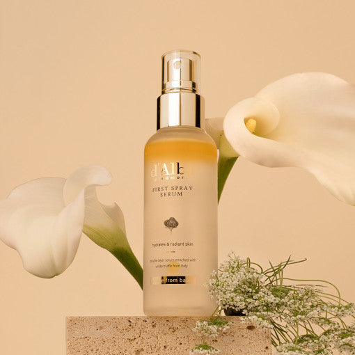 D'ALBA Vegan Yellow Mist First Spray Serum 100ml bottle with flowers.