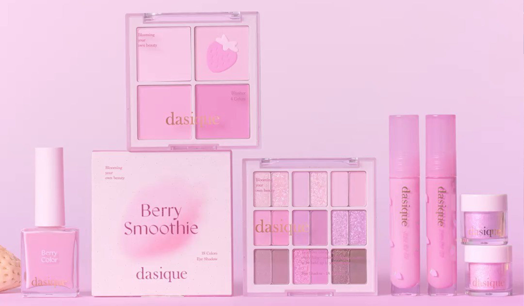 Dasique Berry Smoothie makeup collection featuring nail polish, eyeshadow palette, and lip products in pink hues.