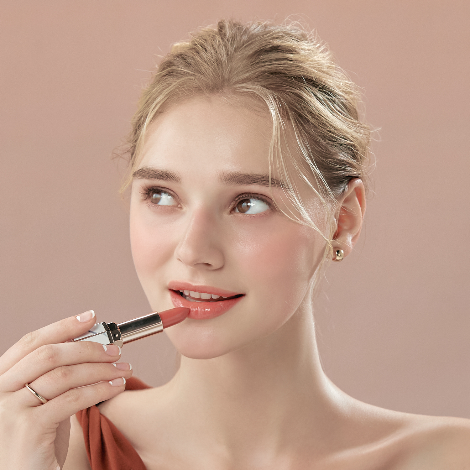 Woman applying DEAR DAHLIA Lip Paradise Sheer Dew Lipstick in pink shade