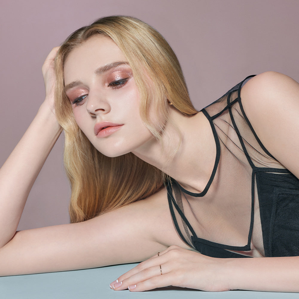 Model showcasing DEAR DAHLIA Perfect Designing Shadow Stick with shimmering eye makeup look.