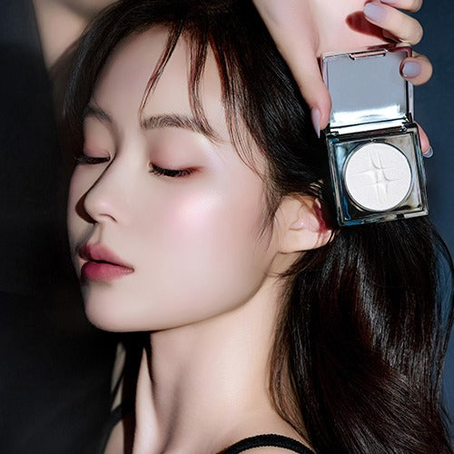 Woman applying DINTO Polaris Shine Highlighter for a luminous glow.