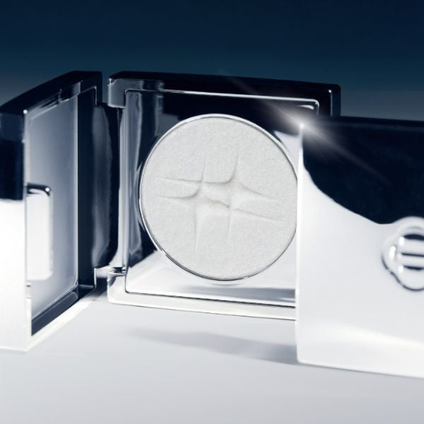 Open packaging of DINTO Polaris Shine Highlighter showcasing a shimmering white compact.