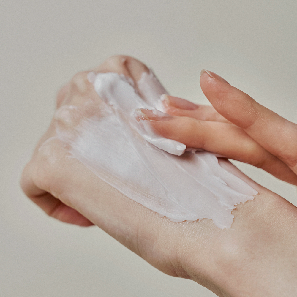 Applying DONGGUBAT Correct Hand Cream Shea Butter on hands for moisturized skin.