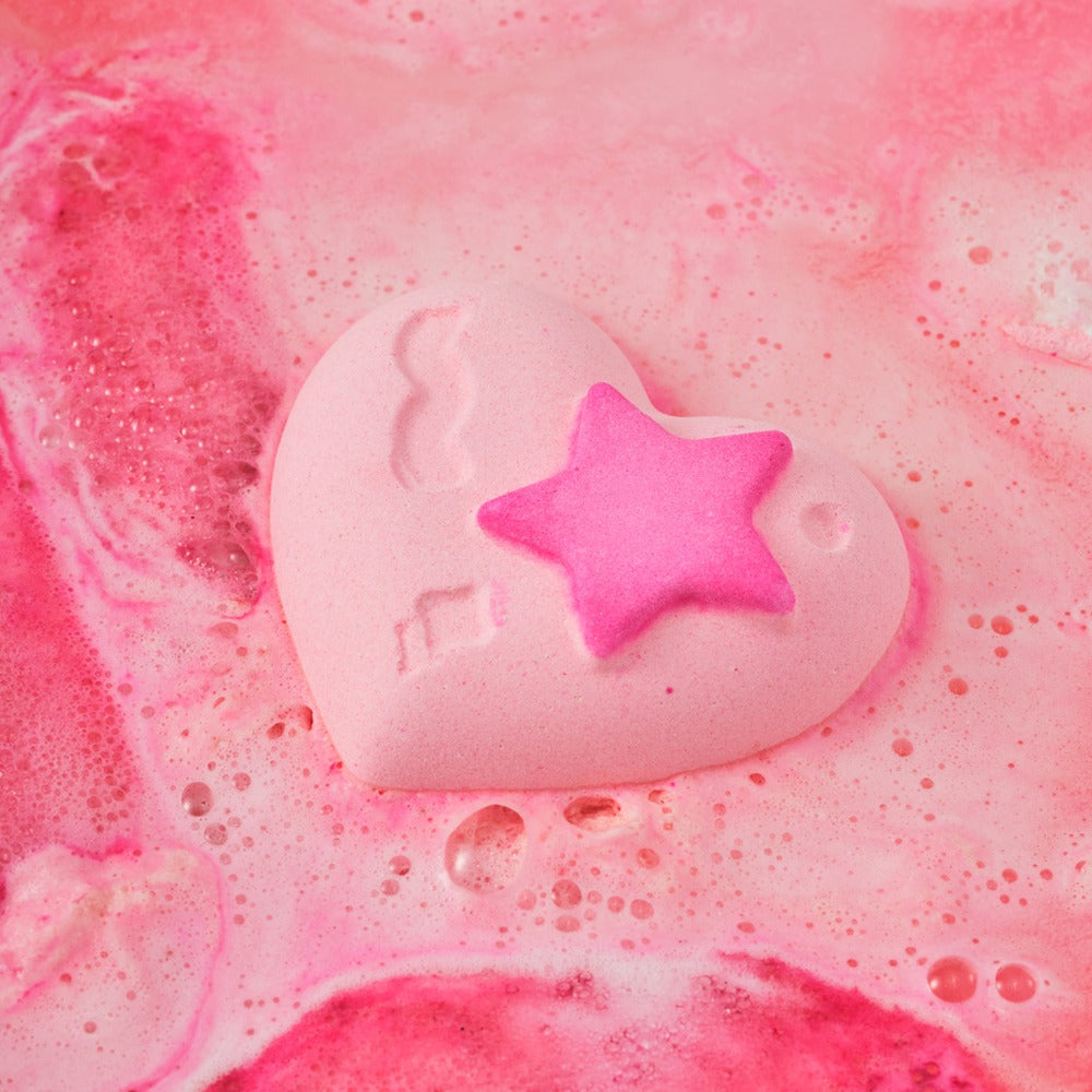 Heart-shaped bath bomb from DONGGUBAT Happy Moment Bath Bomb Set 2 pieces creating pink bubbles in water.