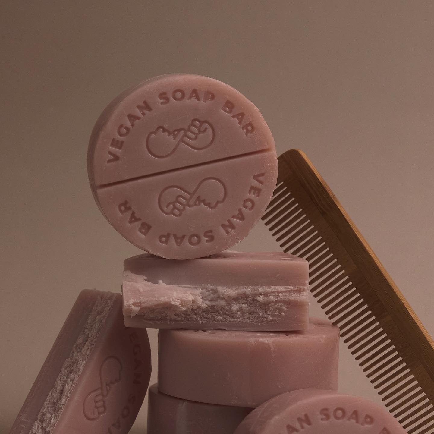 DONGGUBAT Vegan Shampoo Bar Dongbaek stacked with vegan soap bars and a wooden comb in a minimalist setting.