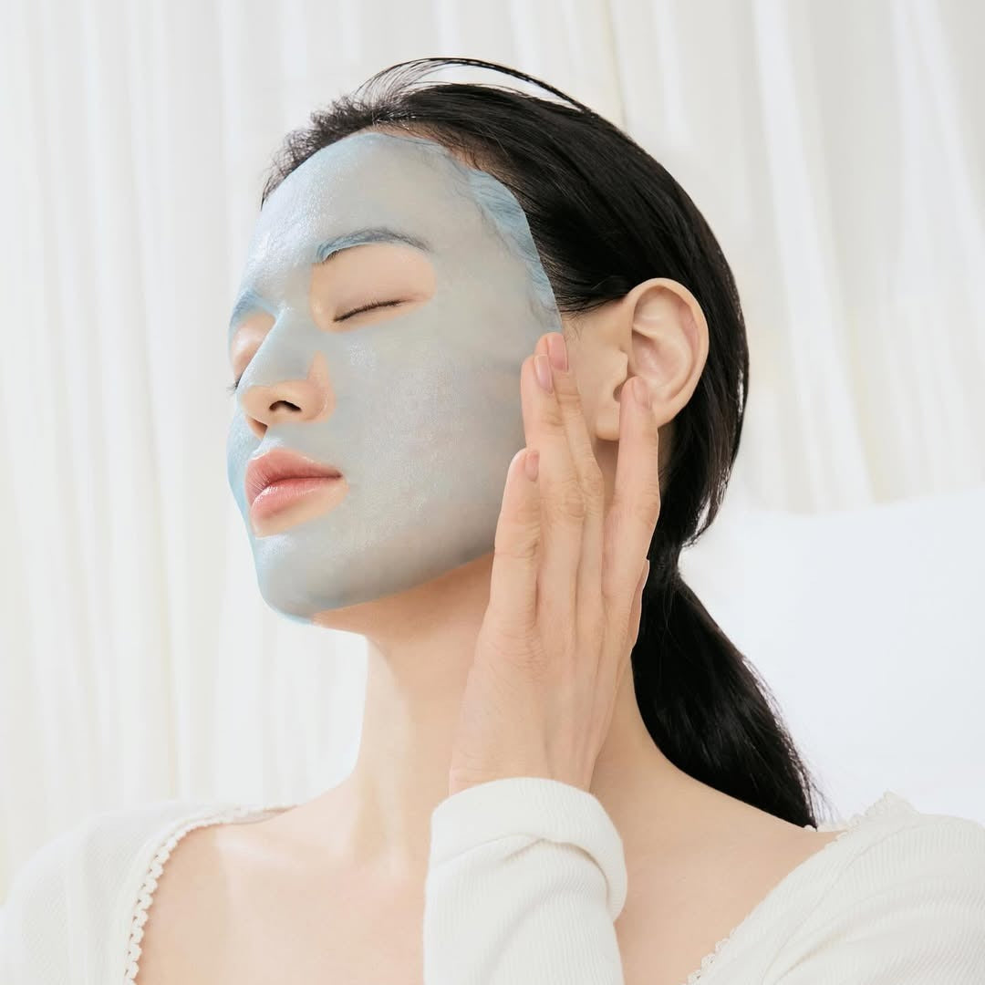 Woman applying DR.ALTHEA Aqua Blue Hydrating Mask (4ea) for skin hydration.