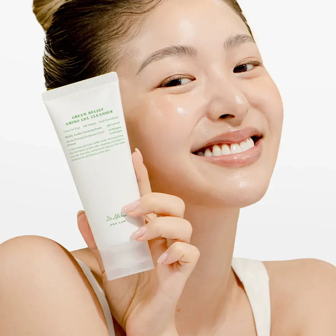 Smiling woman holding DR.ALTHEA Green Relief Amino Gel Cleanser 100ml tube