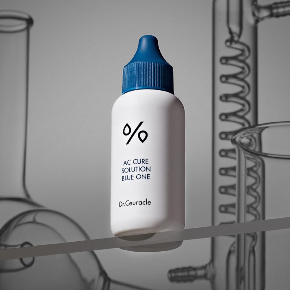 DR.CEURACLE AC Cure Solution Blue One 50ml with focus on the bottle against a scientific background.