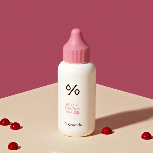 DR.CEURACLE AC Cure Solution Pink Gel 50ml bottle on beige background with red accents.