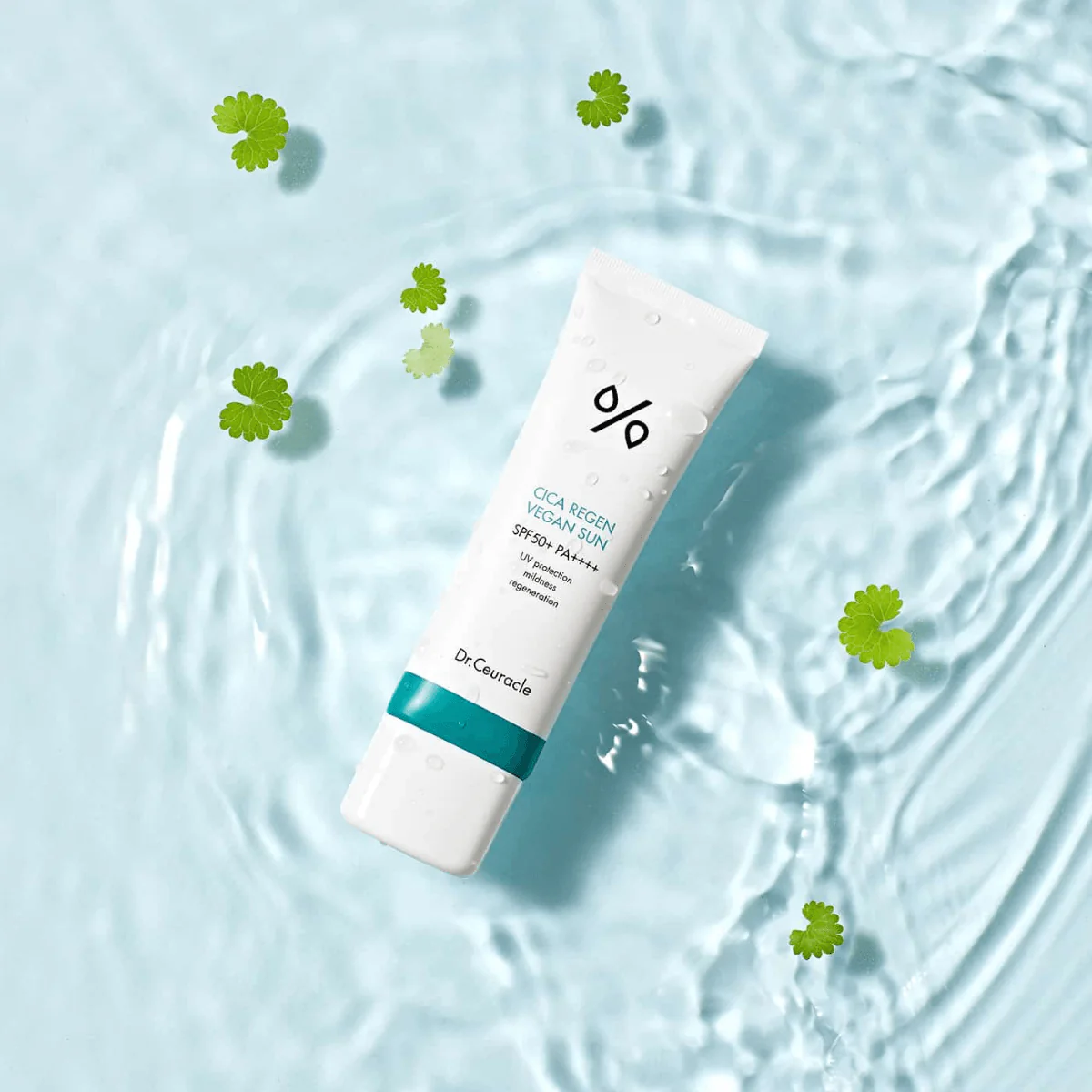 DR.CEURACLE Cica Regan Vegan Sun SPF50+PA++++ 50ml tube on water background with green leaves