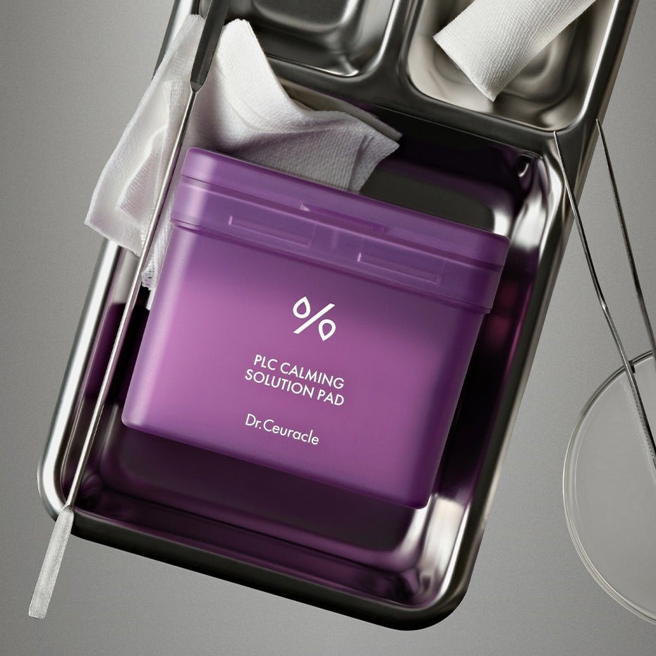 DR.CEURACLE PLC Calming Solution Pad 130 pads in purple packaging on a metal tray.