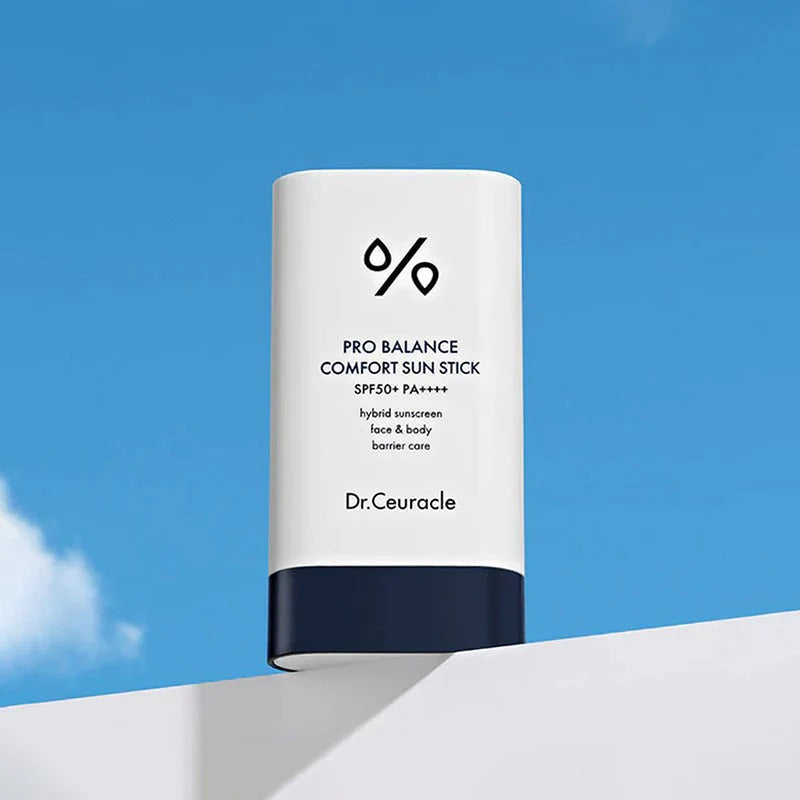 Image of DR.CEURACLE Pro Balance Comfort Sun Stick 18g against a blue sky background with packaging details visible.
