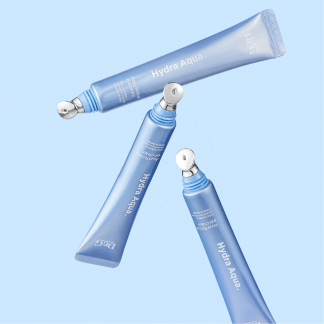 Three tubes of DR.G Hydra Aqua retinol Eye Cream on a blue background