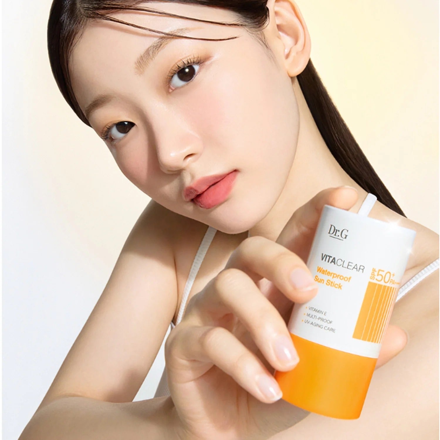 Woman holding DR.G Vita Clear Waterproof Sun Stick 21g showing product texture and packaging.