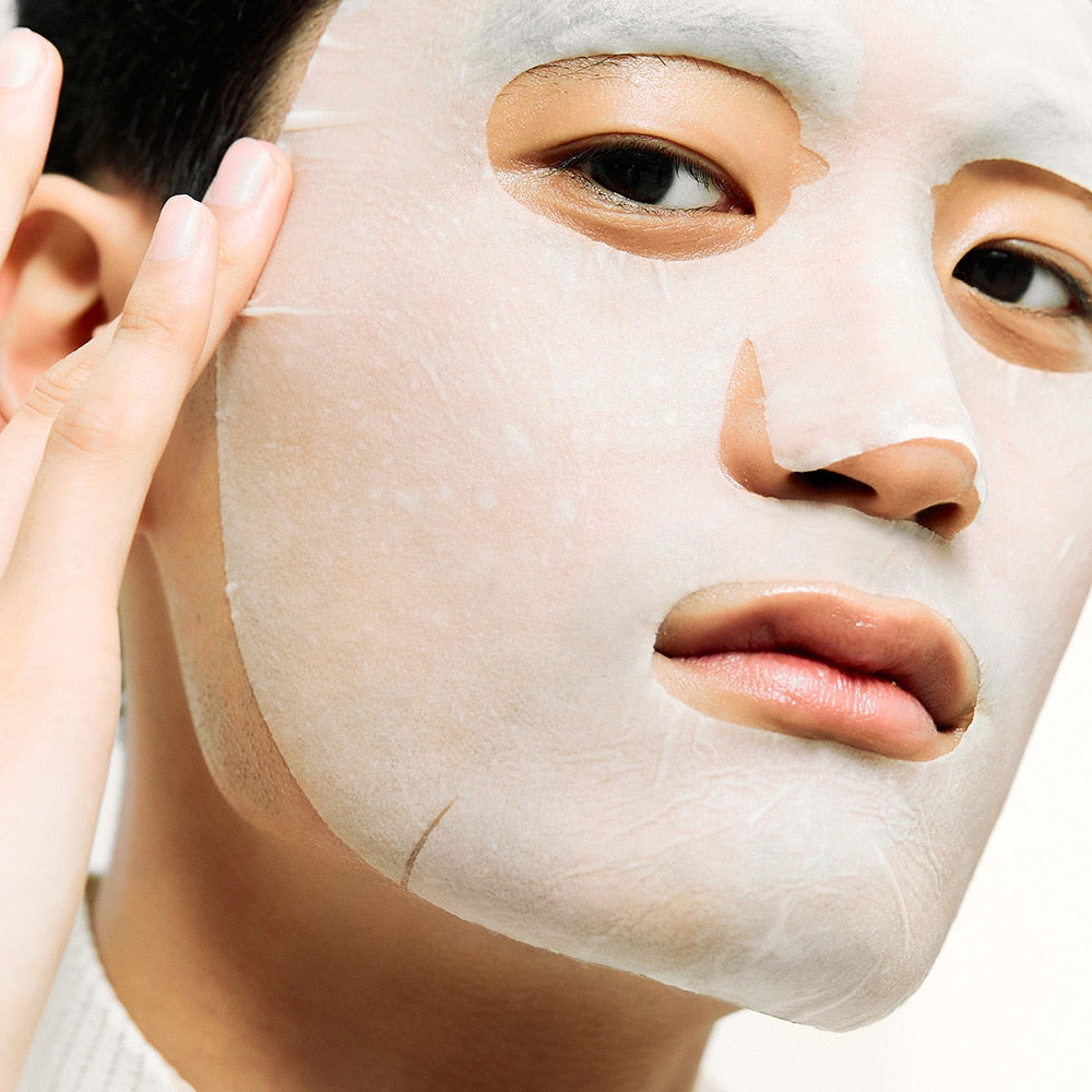 Person applying DR.JART+ Ceramidin Skin Barrier Moisturizing Mask, hypoallergenic sheet mask with natural fibers and ceramides.
