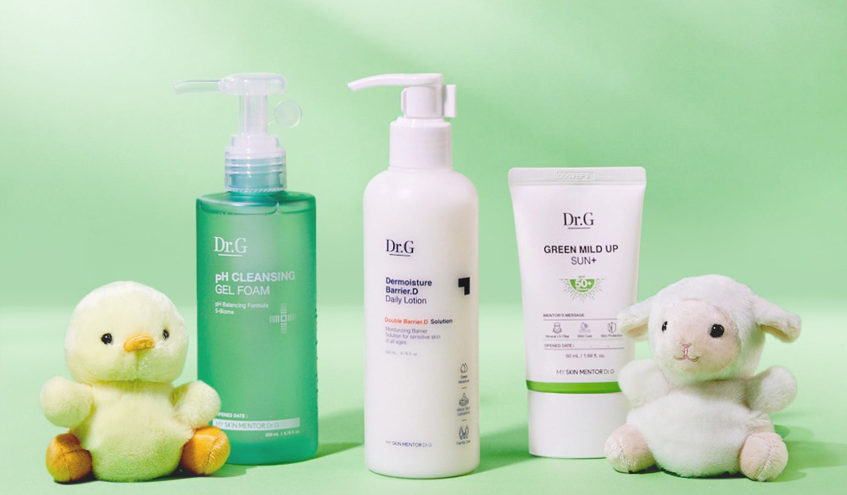 Dr.G skincare products with pH cleansing gel, barrier lotion, and green mild up sun cream, displayed with plush toys on a green background.