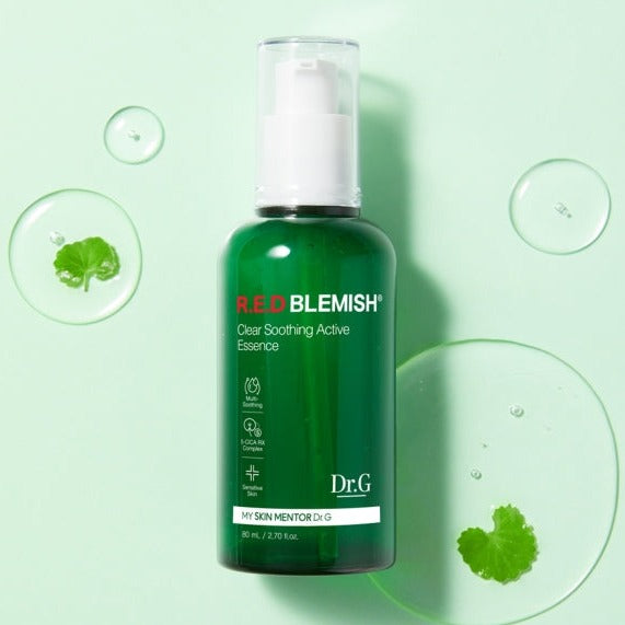 Dr.G Red Blemish Clear Soothing Active Essence 80ml bottle on green background with droplets.