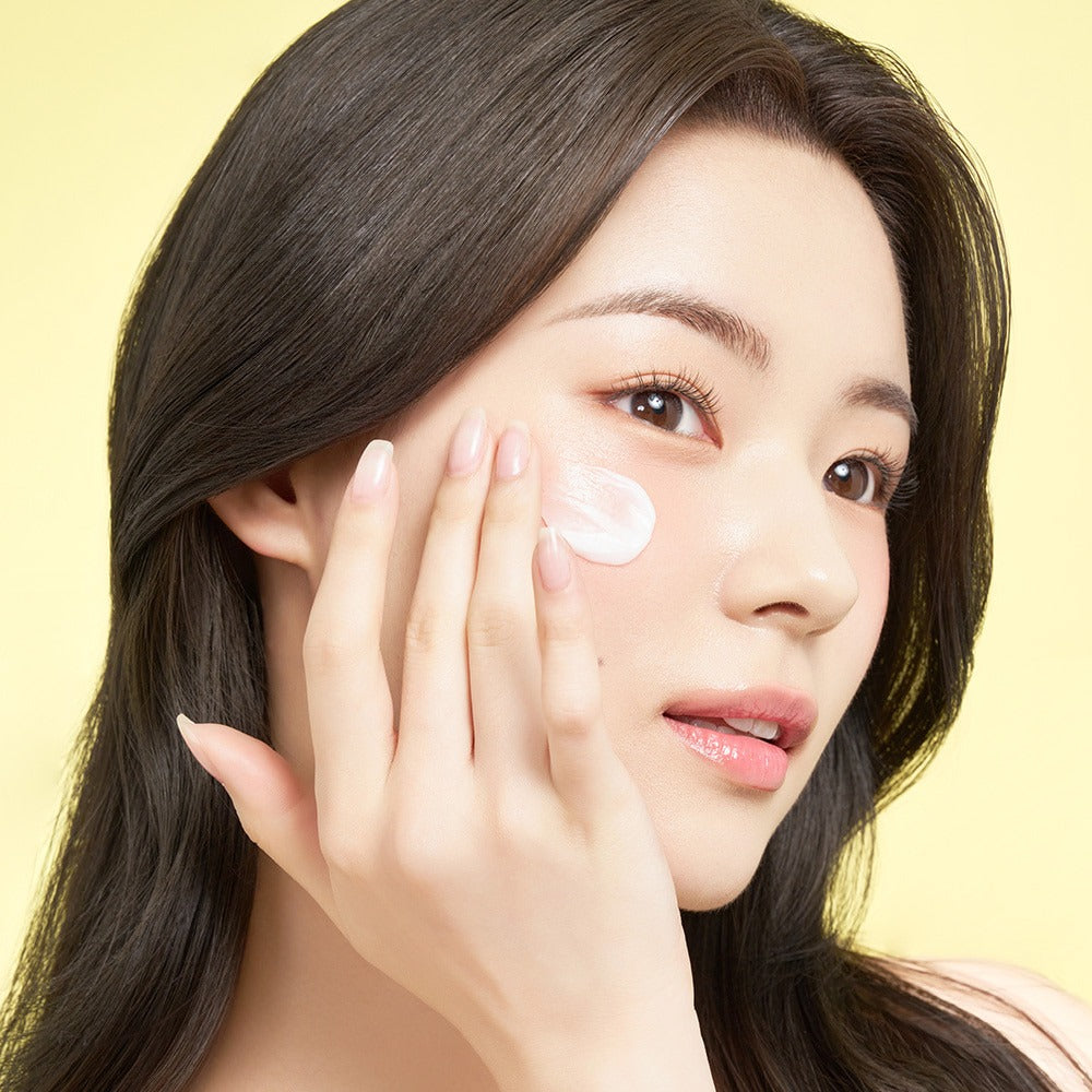 Woman applying EDIT.B Moisturizing Soothing Mugwort Ceramide Cream 100ml on face.