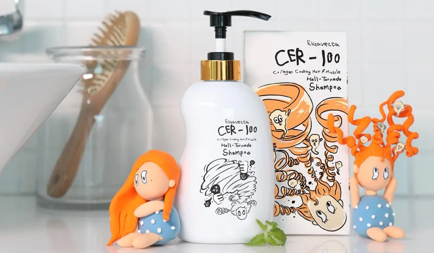 CER-100 shampoo bottle with playful packaging design, accompanied by two orange-haired figurines on a bathroom countertop.