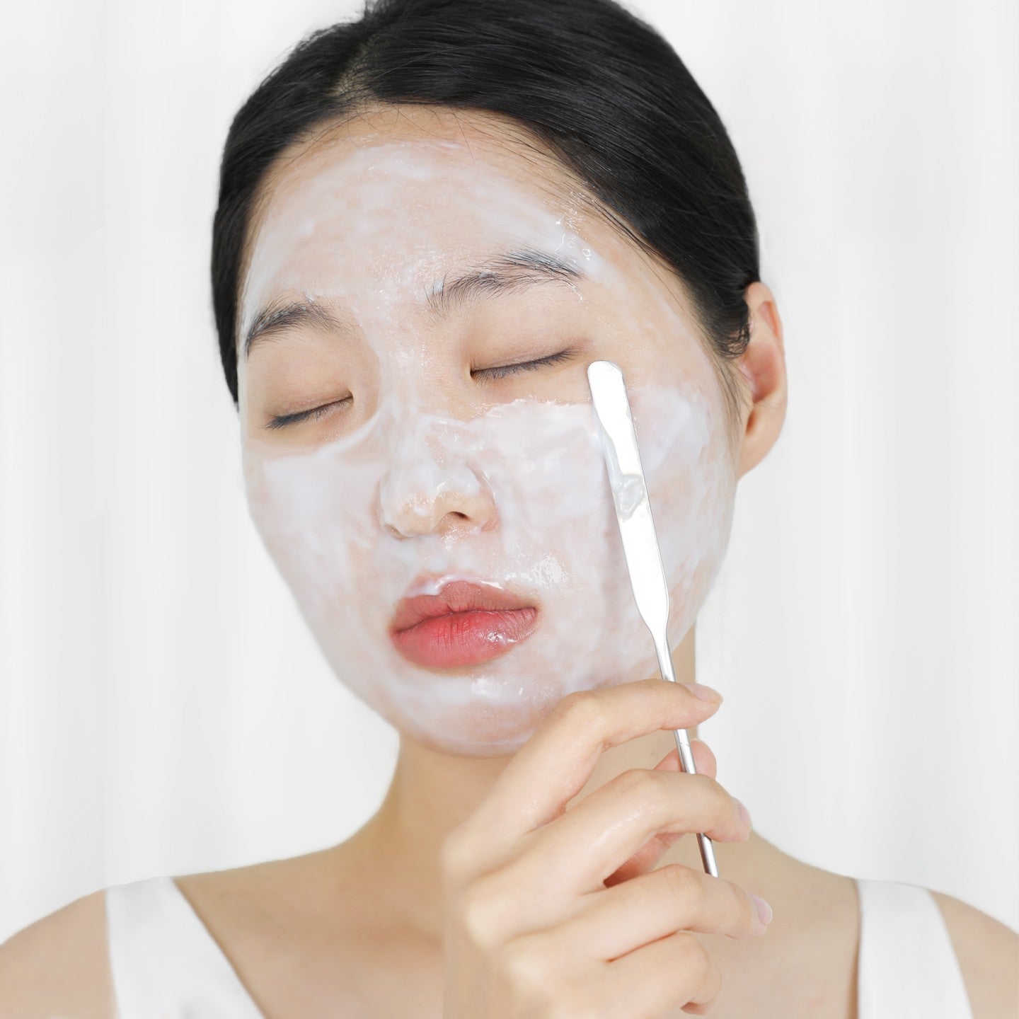 Applying ELIZAVECCA Aqua Water Snail Mushine Cream with a spatula on face for hydrating skincare routine.