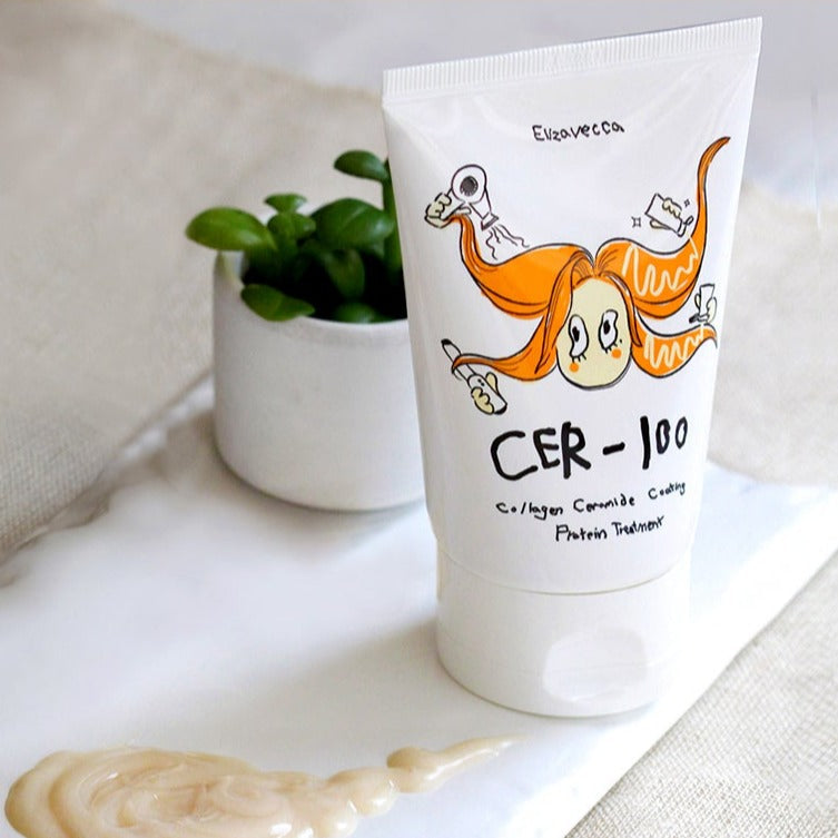 Image of ELIZAVECCA Cer-100 Collagen Ceramide Coating Protein Treatment 100ml tube next to a small plant on a white surface.