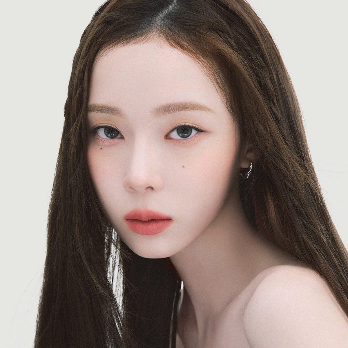 Close-up portrait showcasing precise eyebrow definition using ESPOIR THE BROW EASY SHAPING PENCIL, highlighting natural beauty.