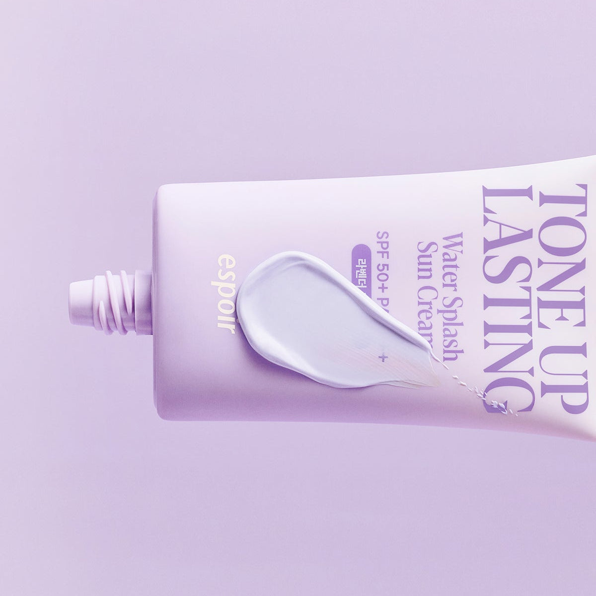 ESPOIR Water Splash Sun Cream Tone Up Lasting SPF 50+ PA++++ tube with cream on a purple background.