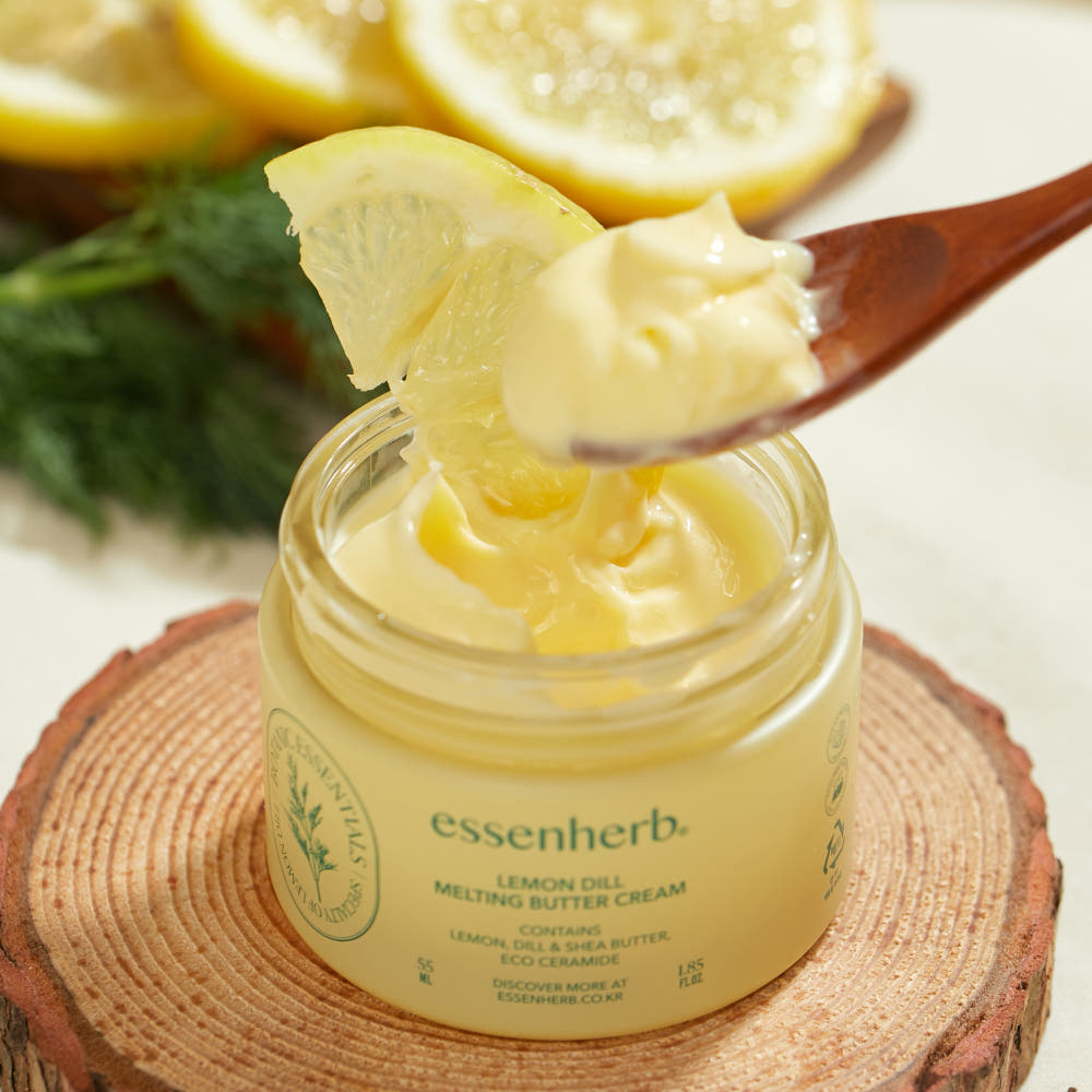 ESSENHERB Lemon Dill Melting Buttercream 55ml in a jar with a spoon and lemon garnish on a wooden slice.