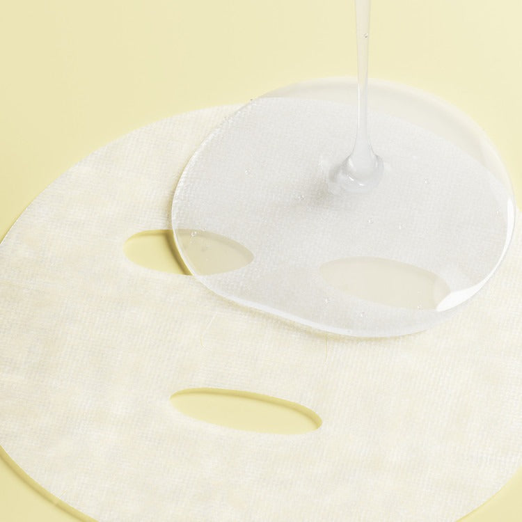 ESSENHERB Lemon Dill Radiant Glow Cotton Mask 5EA with hydrating serum being applied, enhancing skin radiance.