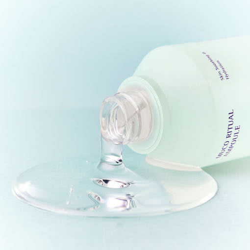 ESSENHERB Mucoritual Ampoule 120ml bottle with ampoule spilling, skincare product.