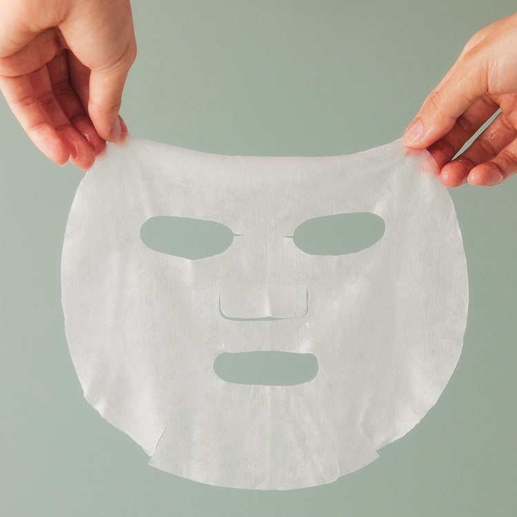 Hands holding an ESSENHERB Tea Tree Relief Cotton Mask from the 5EA pack