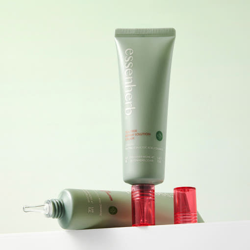 ESSENHERB Tea Tree Repair Solution Cream 50ml displayed on a shelf with two tubes and a red cap.