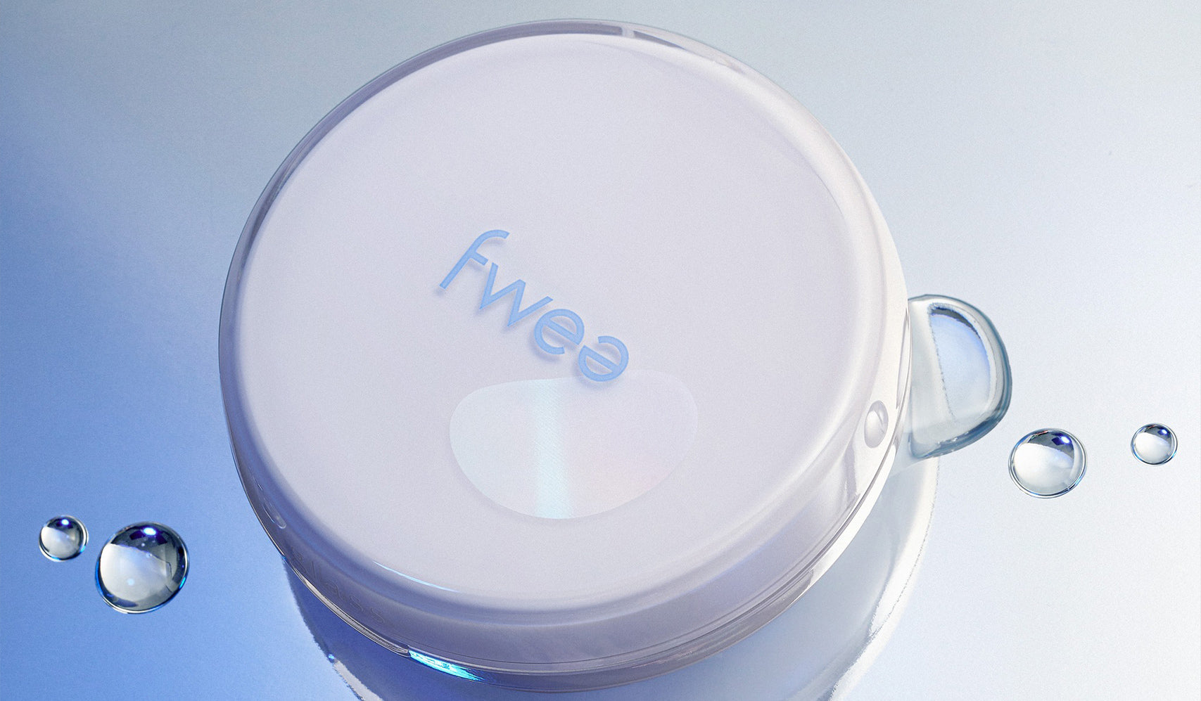 White circular product labeled 'fwee' surrounded by water droplets on a reflective surface