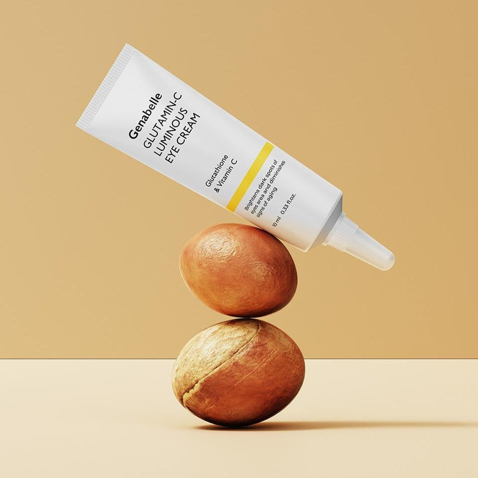 GENABELLE Glutamin-C Luminous Eye Cream 10ml tube balancing on nuts on beige background.