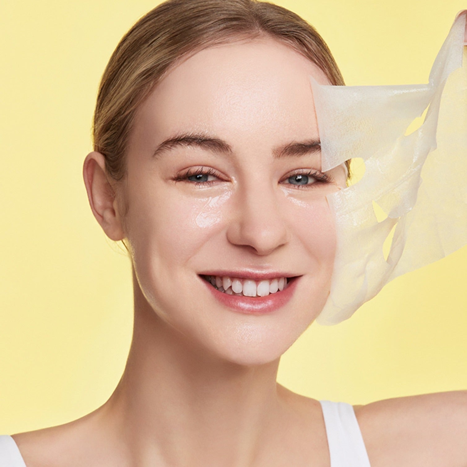 Smiling woman using GENABELLE Glutathione Brightening Ampoule Mask 5ea for skincare routine